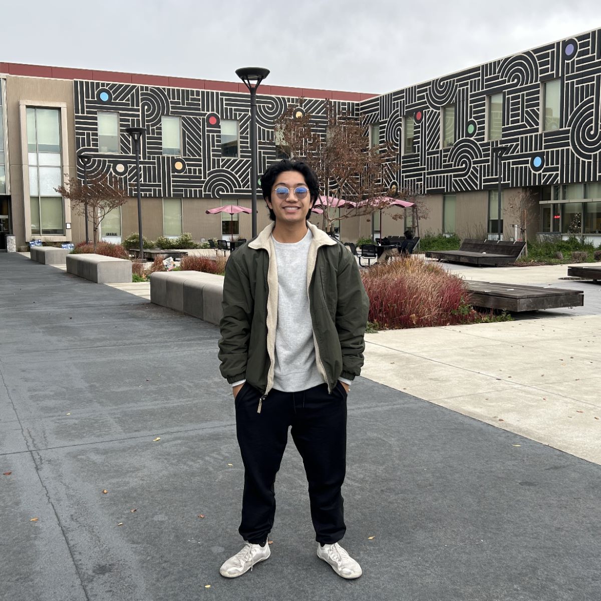 student in front of building