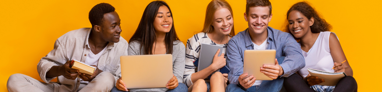 students sitting and looking at the student in the middle's tablet.